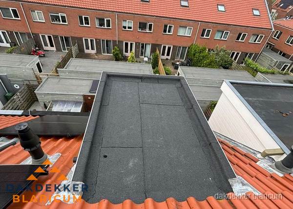 Plat dak met bitumen bedekking naast dakkapel in Blaricum
