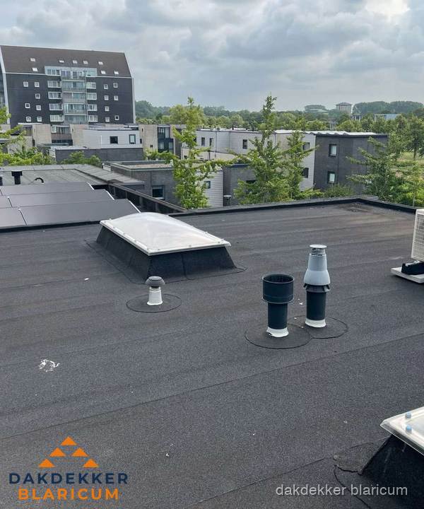 Groot plat dak met lichtkoepel en dakdoorvoeren in Blaricum